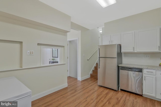 kitchen featuring white cabinetry, light countertops, tasteful backsplash, and stainless steel appliances