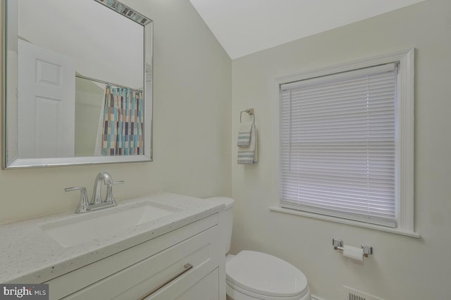 bathroom featuring curtained shower, toilet, and vanity