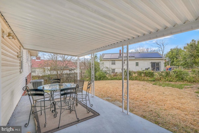 view of patio featuring outdoor dining area and central AC