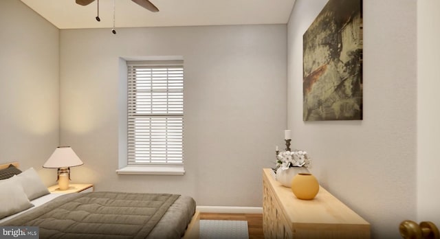 bedroom featuring ceiling fan, wood finished floors, and baseboards