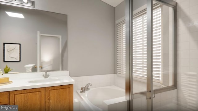 full bathroom featuring a garden tub, double vanity, and a sink