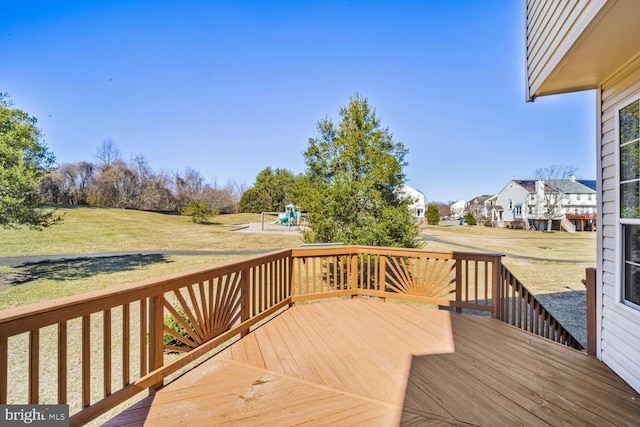 deck with a lawn and a playground