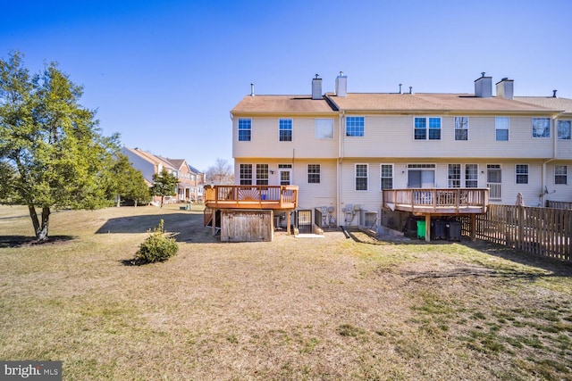 back of property featuring a lawn, fence, a wooden deck, and central air condition unit