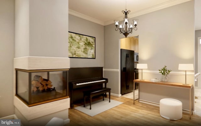 living area featuring ornamental molding, a notable chandelier, light wood-style floors, and baseboards