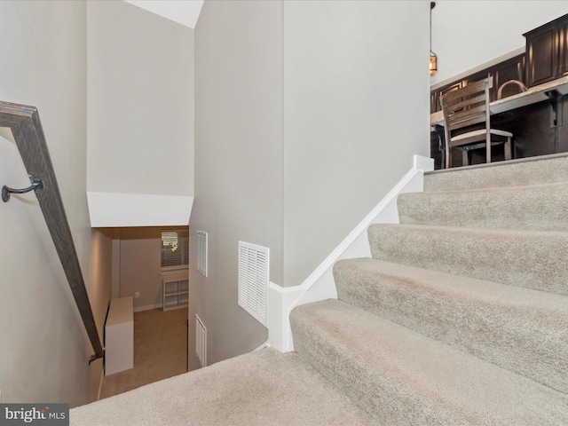 stairs featuring visible vents, carpet flooring, and baseboards