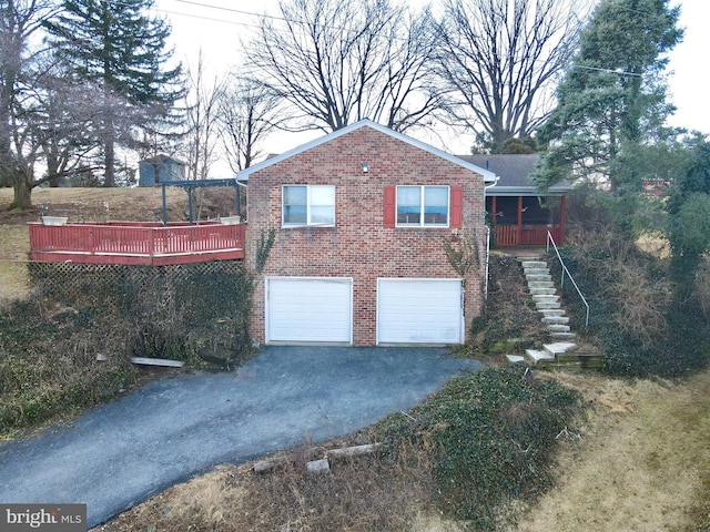 view of property exterior featuring driveway, brick siding, stairway, and an attached garage