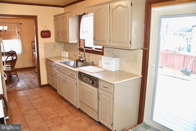 kitchen featuring a wealth of natural light, light countertops, and a sink