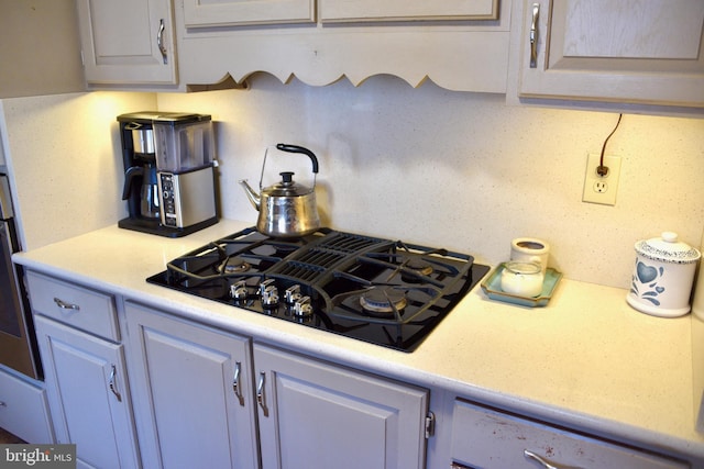 kitchen with black gas cooktop and light countertops