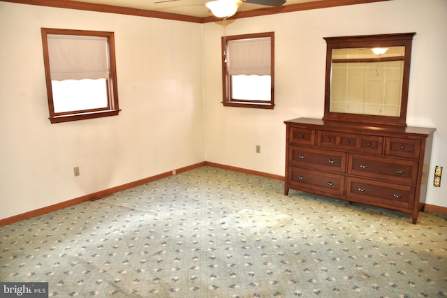 unfurnished bedroom featuring light carpet, multiple windows, and baseboards