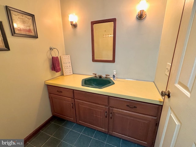 bathroom with tile patterned flooring, vanity, and baseboards