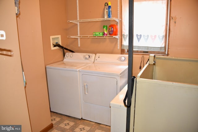 laundry room featuring washing machine and dryer, laundry area, and light floors