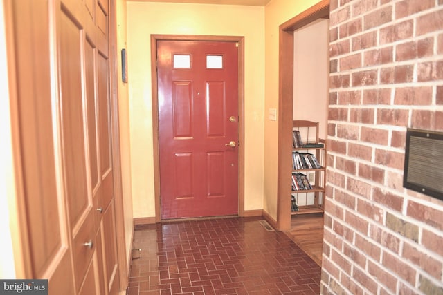 interior space with brick floor and baseboards