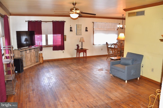 living area featuring ornamental molding, baseboards, visible vents, and hardwood / wood-style floors