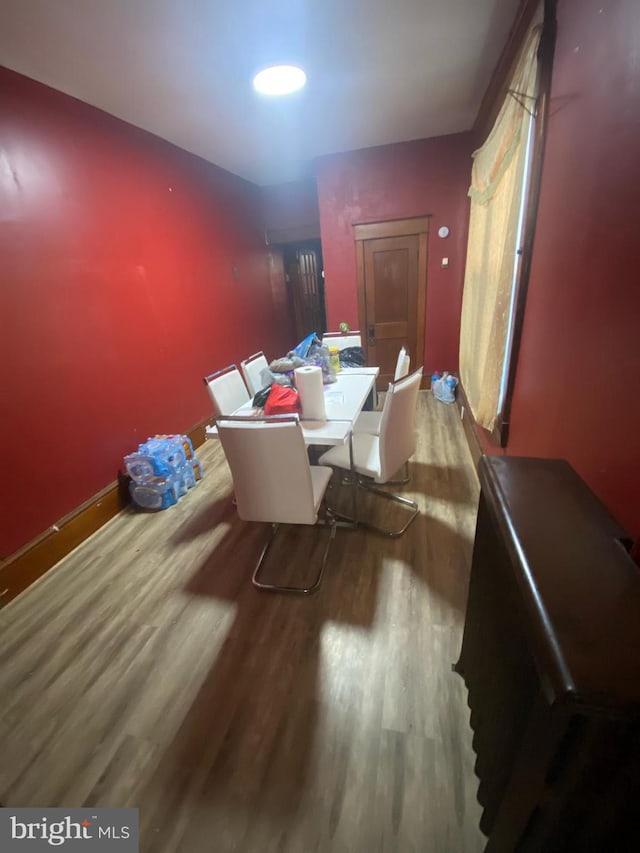 dining area featuring wood finished floors and baseboards