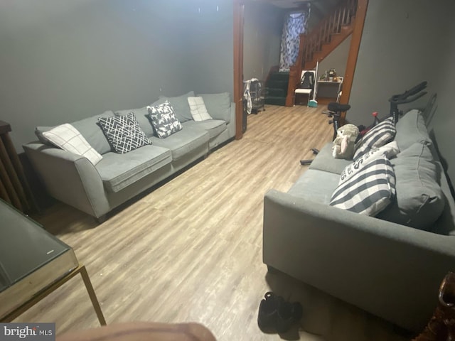 living room featuring stairs and wood finished floors