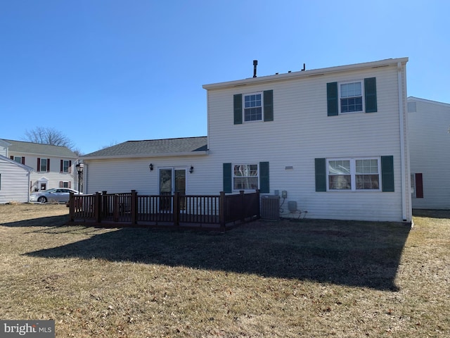 rear view of house with a yard, a wooden deck, and central air condition unit