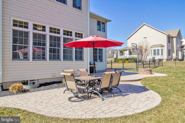 view of patio with outdoor dining space and fence