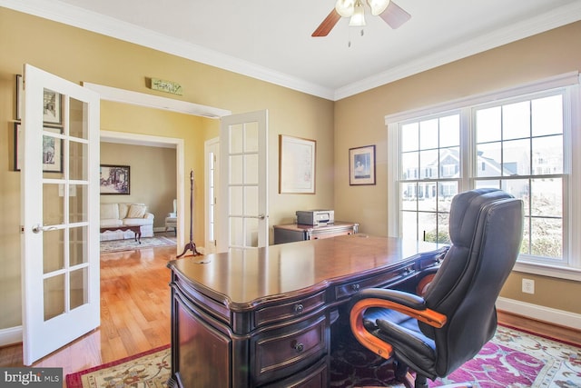 home office featuring wood finished floors, baseboards, ornamental molding, ceiling fan, and french doors