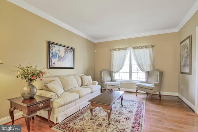 living area featuring baseboards, light wood-style flooring, and crown molding