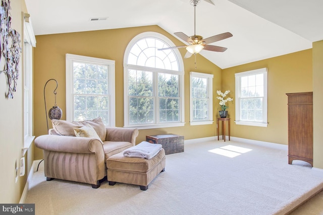 living area featuring visible vents, a ceiling fan, baseboards, carpet, and lofted ceiling