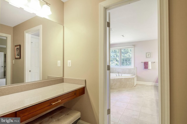 bathroom featuring vanity, tile patterned floors, a bath, and baseboards