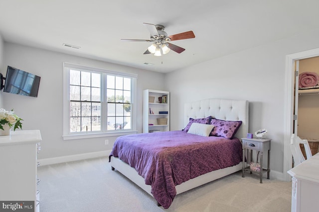 bedroom featuring visible vents, light carpet, baseboards, and a ceiling fan