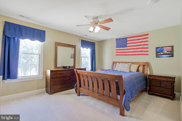 carpeted bedroom featuring visible vents, baseboards, and a ceiling fan