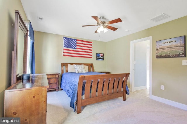 carpeted bedroom featuring baseboards, visible vents, and ceiling fan