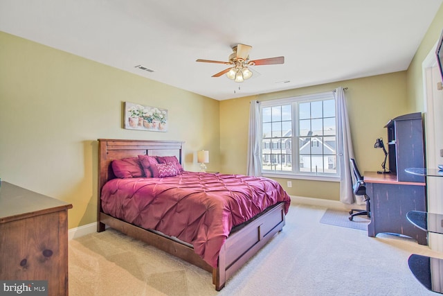 bedroom with visible vents, carpet floors, baseboards, and ceiling fan