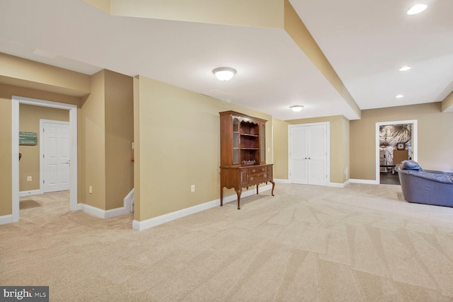 interior space featuring recessed lighting, baseboards, and light carpet