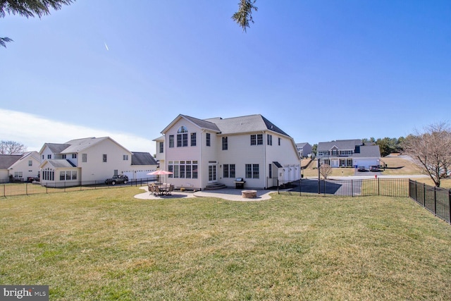 back of house featuring a patio area, a residential view, a lawn, and a fenced backyard