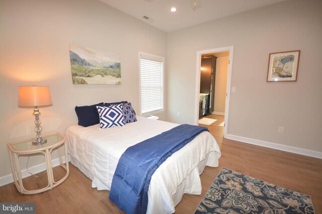 bedroom featuring recessed lighting, visible vents, baseboards, and wood finished floors