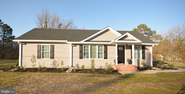 view of front of home featuring roof with shingles