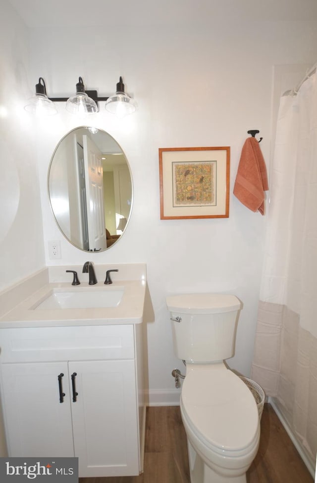 full bathroom with vanity, a shower with shower curtain, wood finished floors, and toilet