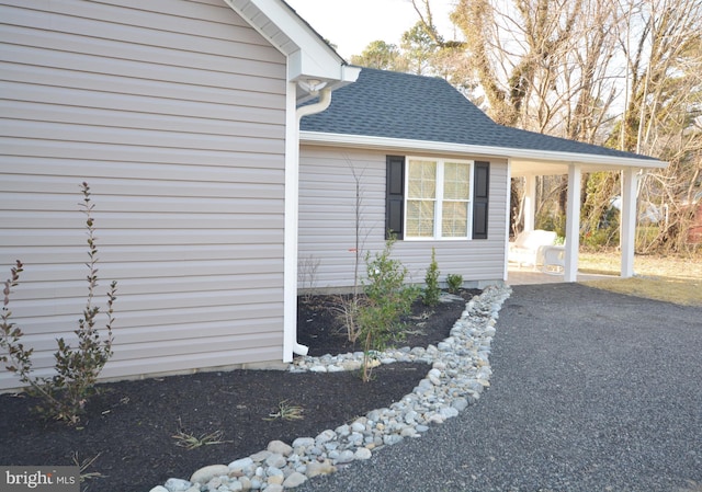 view of side of home featuring a shingled roof