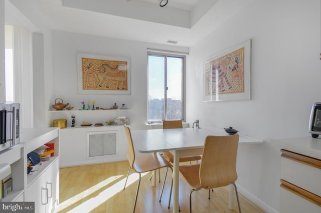 dining area featuring wood finished floors and visible vents