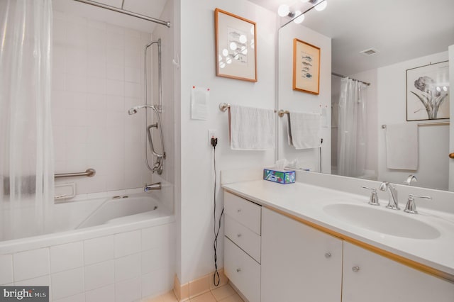 bathroom featuring tiled shower / bath, visible vents, vanity, and tile patterned floors