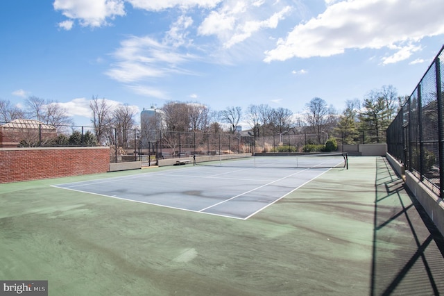 view of tennis court with fence