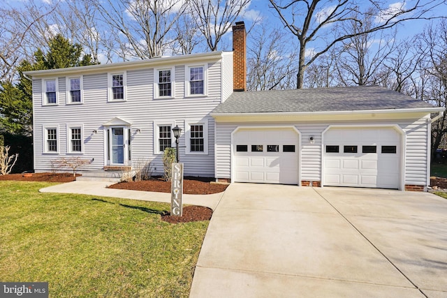 colonial house with roof with shingles, a front yard, a chimney, a garage, and driveway