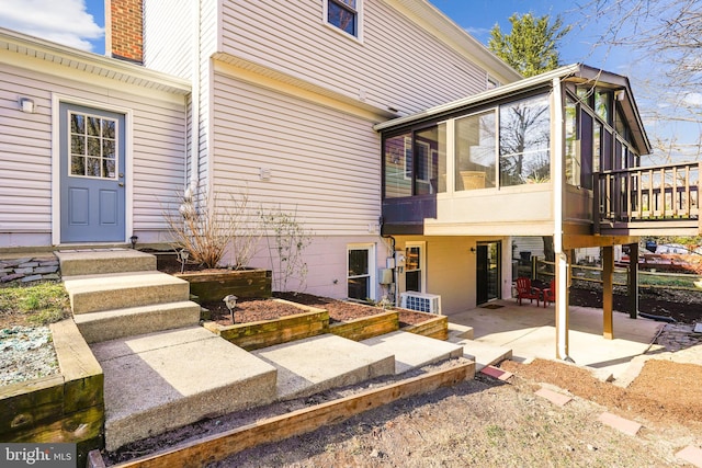 entrance to property featuring a patio