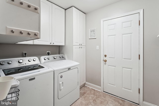 laundry room with cabinet space, light tile patterned floors, baseboards, and separate washer and dryer