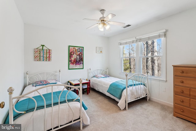 bedroom featuring a ceiling fan, carpet, visible vents, and baseboards