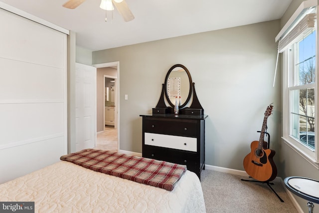 carpeted bedroom featuring a ceiling fan and baseboards