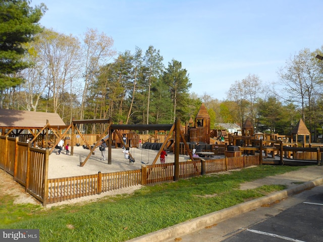 view of play area featuring a lawn and fence