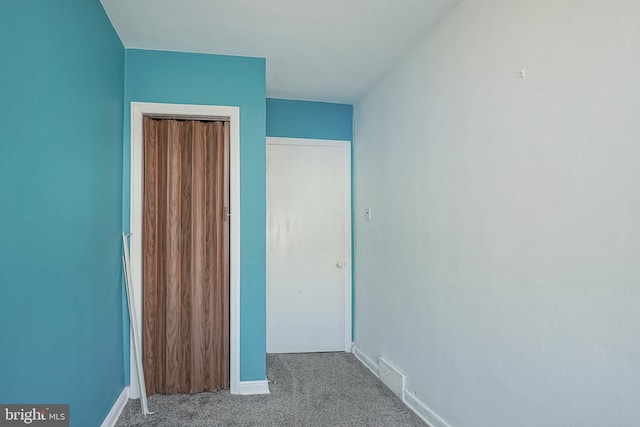 unfurnished bedroom with carpet, a closet, visible vents, and baseboards