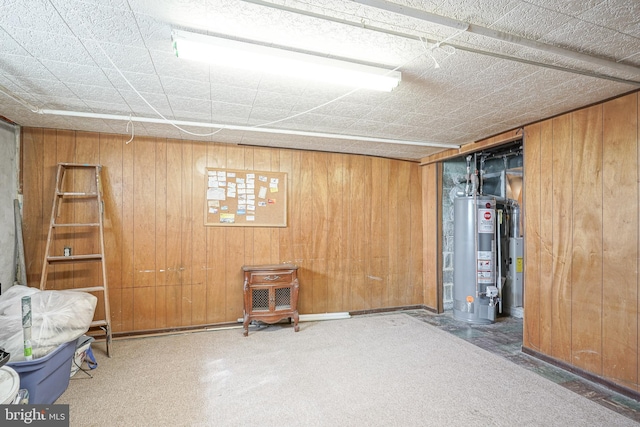 interior space with water heater and wood walls