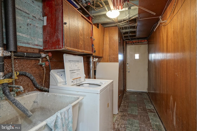 washroom featuring washer / clothes dryer, a sink, and cabinet space