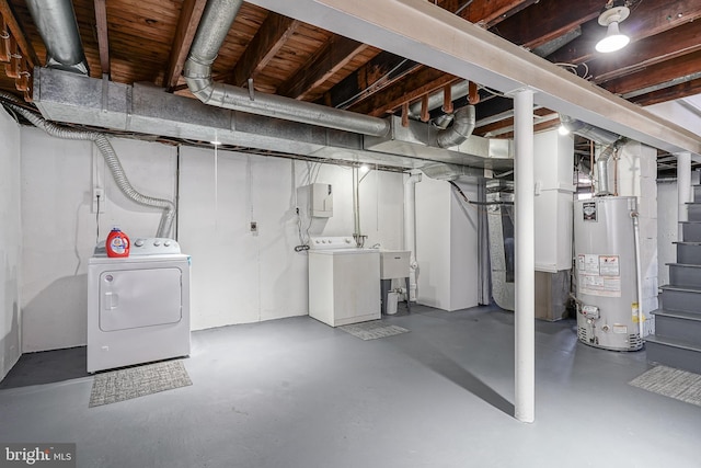 unfinished basement featuring separate washer and dryer and gas water heater