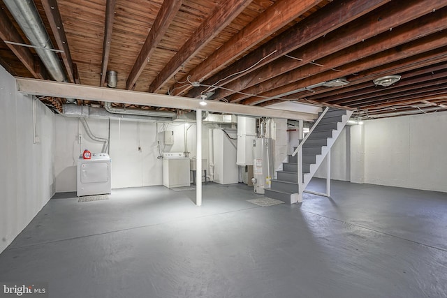 unfinished below grade area featuring washer and dryer, gas water heater, and stairs