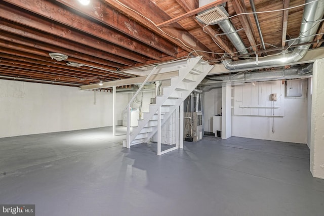 unfinished basement with washer / clothes dryer and stairway